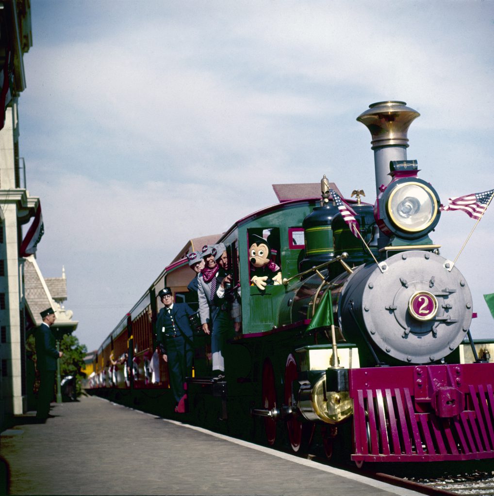 Mickey Mouse riding the Circus train at Disneyland which is a replica of Casey Jr.'s train used in the movie Dumbo ,1955.