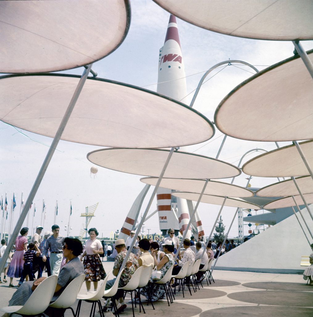 People resting by TWA rocket at Disneyland Amusement Park, 1955.