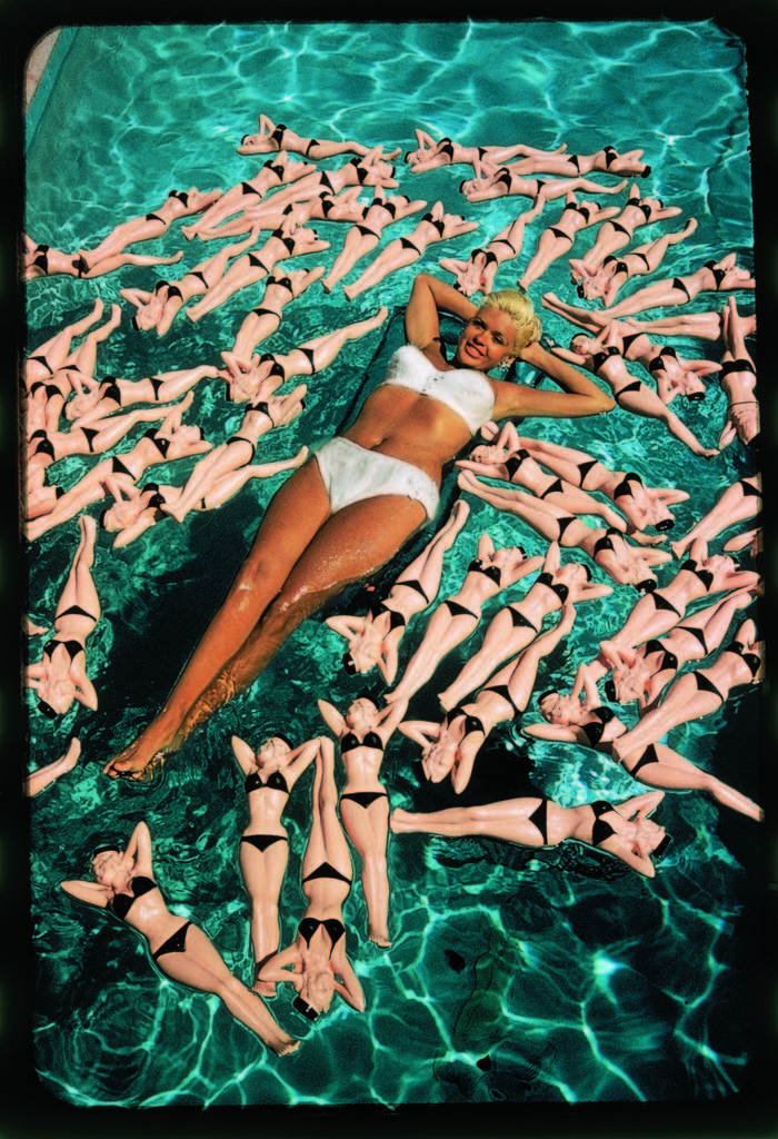 Bikini clad actress Jayne Mansfield posing with shapely bottles floating around her in her pool. (Photo by Allan Grant/The LIFE Picture Collection © Meredith Corporation).